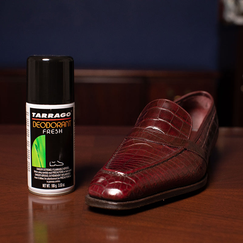 A Tarrago Fresh Deodorizing Spray next to a bottle of shoe polish on a table from KirbyAllison.com.