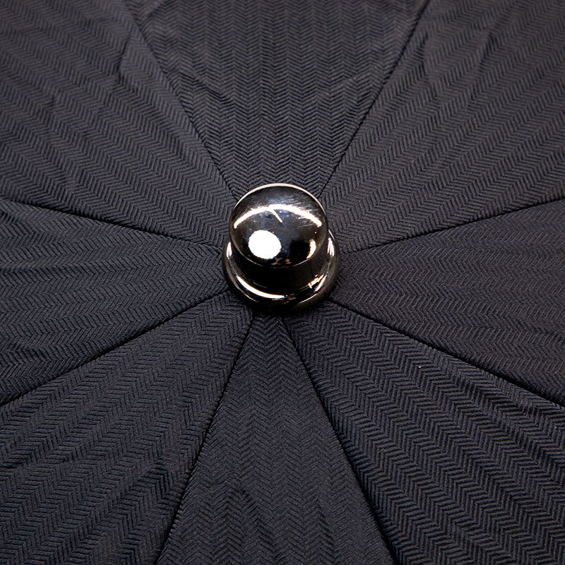 A Black Herringbone Canopy Travel Umbrella with a silver ball on it, perfect for rainy days in Milan, Italy. The KirbyAllison.com umbrella.
