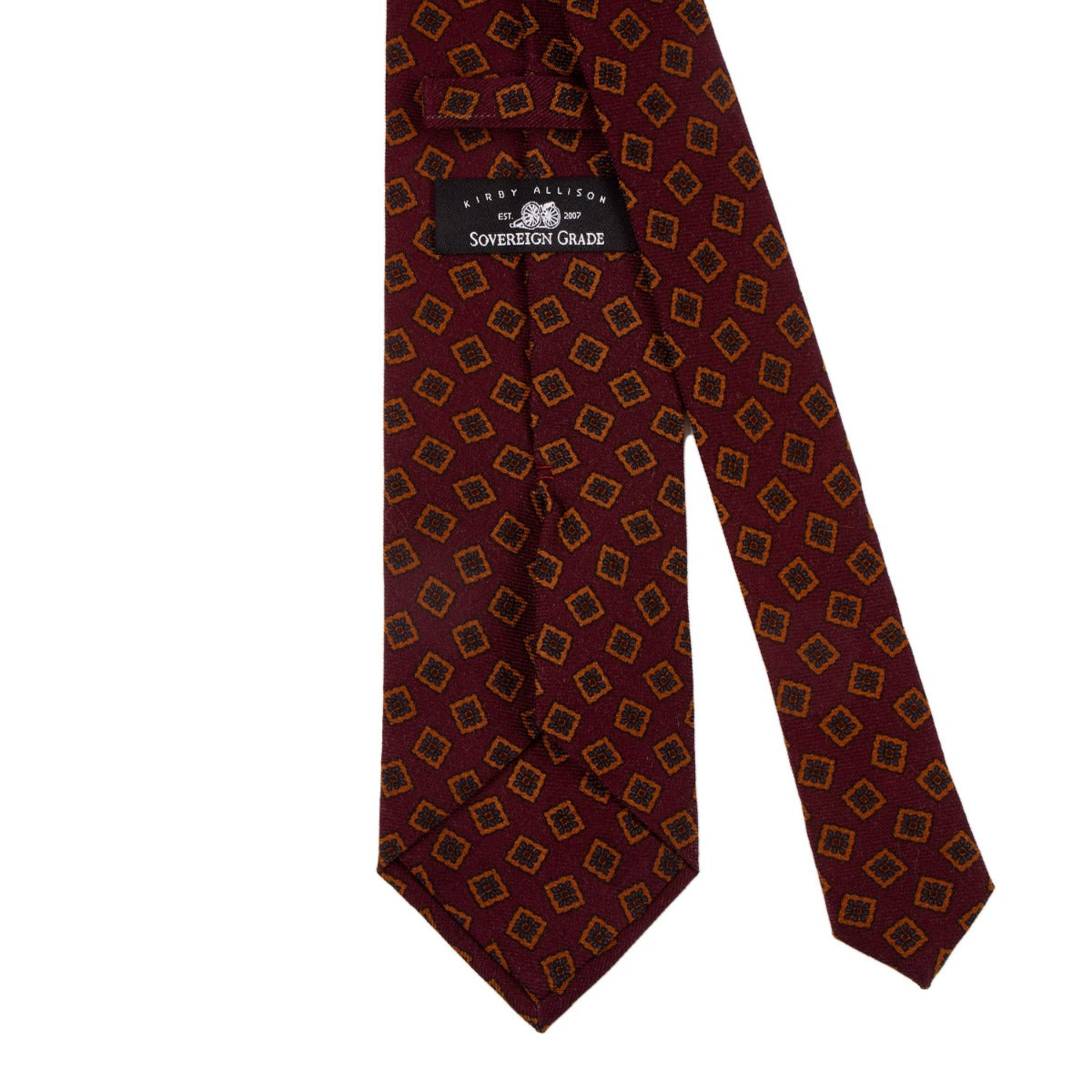 A Sovereign Grade Burgundy Tossed Square Wool Challis Tie with a red and gold pattern, handmade in the United Kingdom by KirbyAllison.com.