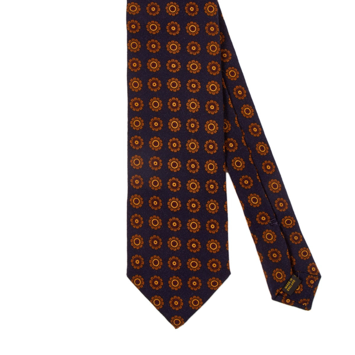 A handmade KirbyAllison.com ties with orange and blue circles on it, named Sovereign Grade Navy Daisy Wool Challis Tie.